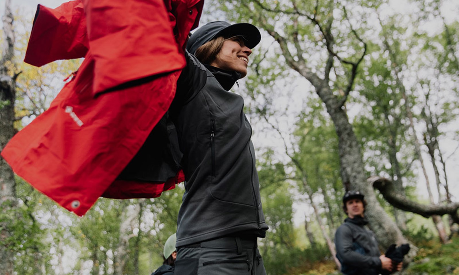 En person der tager en jakke på.