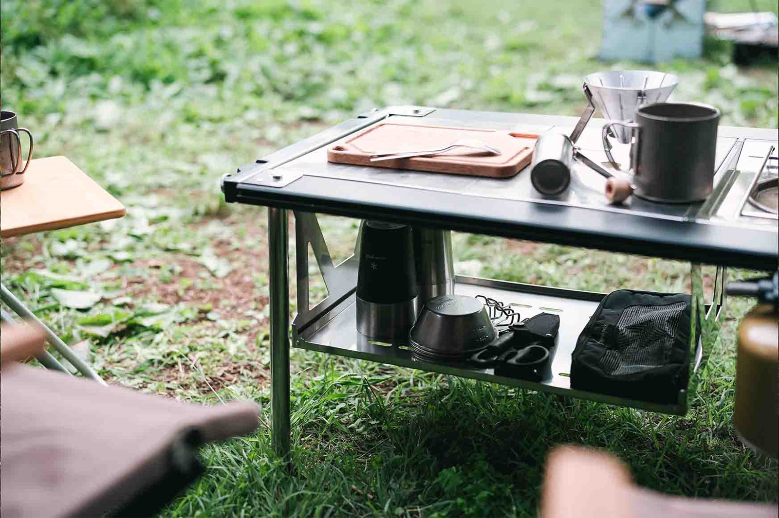 Et lavt IGT bord med en hylde der hænger under med grej på.