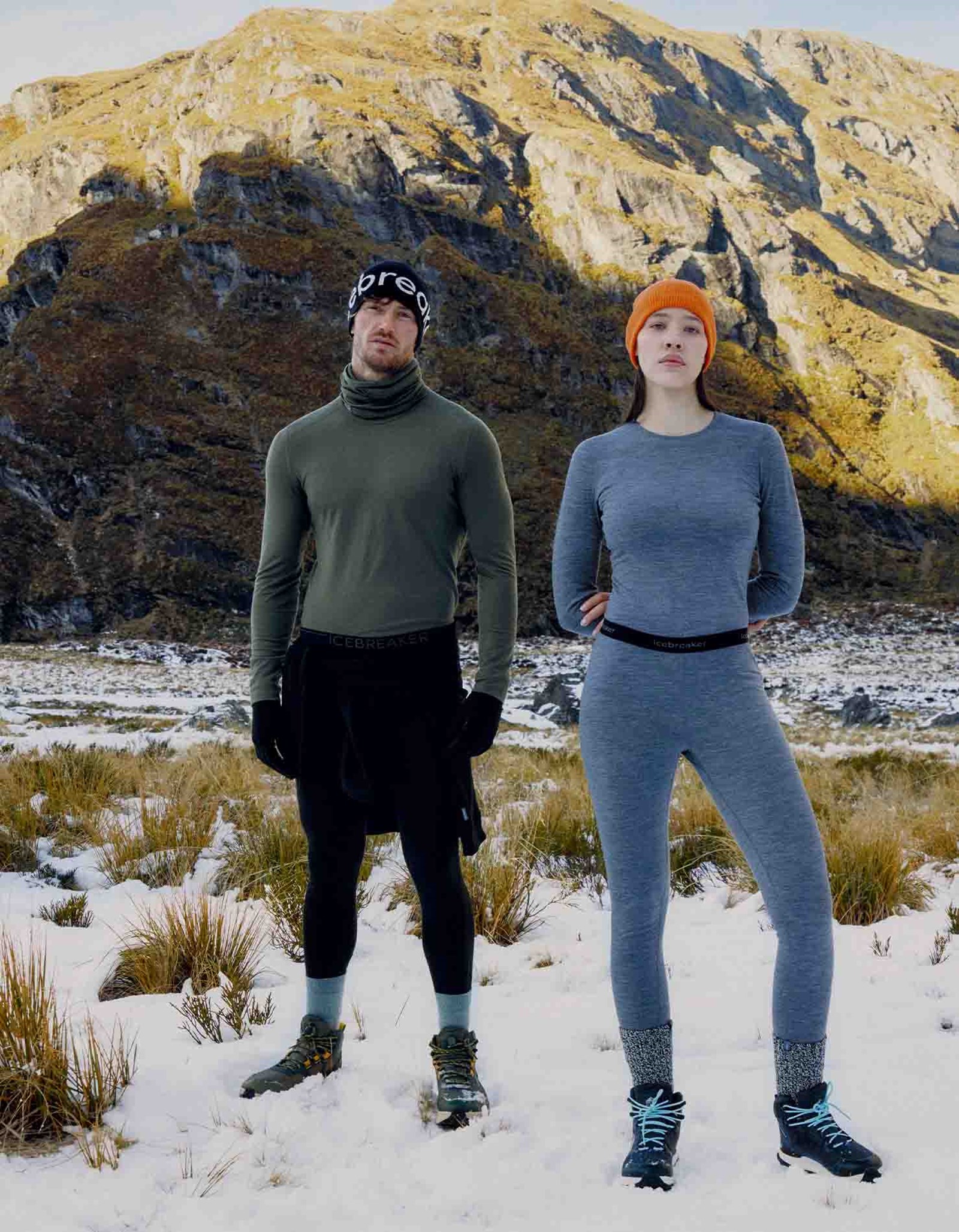 To personer i Oasis 200 undertøj foran et bjerg.