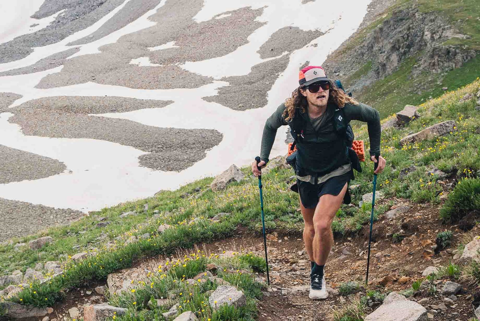Mand på vej opad med sine vandrestave.