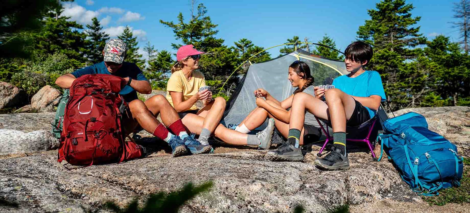 Folk på teltur med deres Osprey rygsække.